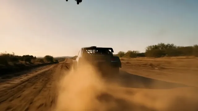 Runway Gen-4.5 — A helicopter chases a speeding race car down a dirt road. The sky is delicately colored with lig