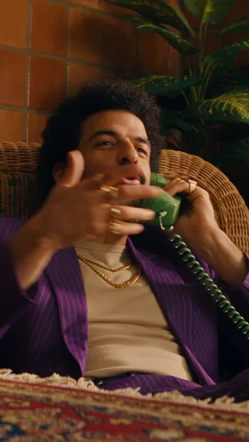 Seedance 2.5 — A split-location phone call fused into one take by a single violent whip pan. Duration 5s, verti